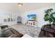 Comfortable living room with a large sectional sofa, stylish rug, and entertainment center at 9229 52Nd E Ave, Palmetto, FL 34221