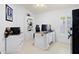 Bright office featuring white wood floors, built-in bookshelf, and an ornate desk with computer setup at 9229 52Nd E Ave, Palmetto, FL 34221