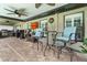 The patio features an outdoor kitchen, a dining area, and a view of the screen enclosed pool at 9229 52Nd E Ave, Palmetto, FL 34221