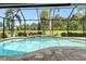 Beautiful pool with a screen enclosure and lovely views of palm trees and the adjacent green space at 9229 52Nd E Ave, Palmetto, FL 34221