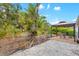 Expansive backyard with gravel, an outdoor patio with gazebo, and a lush green lawn at 928 Pineland Ave, Venice, FL 34285
