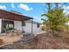 Relaxing outdoor patio with a gazebo, table, chairs, and a view of the home's exterior at 928 Pineland Ave, Venice, FL 34285