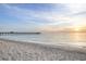 Scenic view of the Venice Fishing Pier extending into the ocean at sunset from the tranquil, sandy beach at 928 Pineland Ave, Venice, FL 34285
