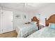 Charming bedroom with two twin beds, turtle artwork, and a ceiling fan at 928 Pineland Ave, Venice, FL 34285