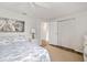 Comfortable bedroom featuring a ceiling fan, closet, neutral decor, and soothing artwork at 928 Pineland Ave, Venice, FL 34285