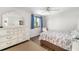 Bright bedroom with a white dresser, blue curtains, and an outdoor view at 928 Pineland Ave, Venice, FL 34285
