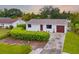 Charming single-story home with a well-manicured front yard and a one car garage at 928 Pineland Ave, Venice, FL 34285
