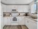 Well-lit kitchen with white cabinets, offering modern appliances and ample countertop space at 928 Pineland Ave, Venice, FL 34285