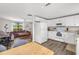 Open-concept kitchen flows into the living room, featuring white cabinets and modern appliances at 928 Pineland Ave, Venice, FL 34285