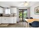 Eat-in kitchen with white cabinets, modern appliances, and sliding door access to the patio at 928 Pineland Ave, Venice, FL 34285