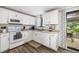 Bright kitchen with white cabinets and stainless steel appliances, ideal for cooking and entertaining at 928 Pineland Ave, Venice, FL 34285