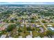 Expansive overhead view of a residential neighborhood featuring a mix of homes, streets, and mature trees at 928 Pineland Ave, Venice, FL 34285