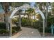 Entrance to the Venice Fishing Pier, lush landscaping, and brick path creating a welcoming atmosphere at 928 Pineland Ave, Venice, FL 34285