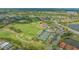 Wide aerial shot of the golf course, tennis courts, and community at 9540 High Gate Dr # 1422, Sarasota, FL 34238