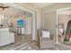Welcoming sunroom view to main rooms, with stylish chair and golf course scenery at 9540 High Gate Dr # 1422, Sarasota, FL 34238