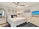 Cozy bedroom with plush king bed, decorative pillows, modern ceiling fan and a TV at 9540 High Gate Dr # 1422, Sarasota, FL 34238