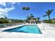 Sparkling community pool with a gazebo, lounge chairs, and tropical palm trees at 9540 High Gate Dr # 1422, Sarasota, FL 34238