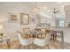 This dining area features a glass table and decorative chandelier adjacent to the kitchen and living area at 9540 High Gate Dr # 1422, Sarasota, FL 34238