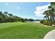 Beautiful view of a golf course with a pond surrounded by lush green grass and trees at 9540 High Gate Dr # 1422, Sarasota, FL 34238
