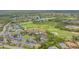 Aerial view highlighting the golf course, tennis courts, pool, and clubhouse at 9540 High Gate Dr # 1422, Sarasota, FL 34238