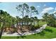 Picturesque golf course view with palm trees lining a pathway and a tranquil pond at 9540 High Gate Dr # 1422, Sarasota, FL 34238