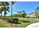 Expansive golf course view with manicured lawns and surrounding trees next to a building at 9540 High Gate Dr # 1422, Sarasota, FL 34238