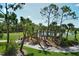 Scenic view of the golf course with lush greenery, palm trees, and a serene pond at 9540 High Gate Dr # 1422, Sarasota, FL 34238