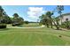 Wide view of a lush green golf course with a pond and trees on a sunny day at 9540 High Gate Dr # 1422, Sarasota, FL 34238