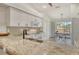 Well-lit kitchen featuring granite countertops, white cabinets, stainless appliances and access to the screened in lanai at 9540 High Gate Dr # 1422, Sarasota, FL 34238