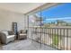 Screened lanai offering comfortable seating, a decorative shelf, and beautiful views of lush landscaping at 9540 High Gate Dr # 1422, Sarasota, FL 34238