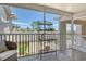 Screened lanai featuring a seating area and shelf overlooking a lush landscape with views of nearby buildings at 9540 High Gate Dr # 1422, Sarasota, FL 34238