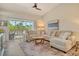 Comfortable living room featuring large sectional, vaulted ceilings, and screened balcony access at 9540 High Gate Dr # 1422, Sarasota, FL 34238