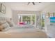 Bright main bedroom with large windows offering serene views of a pond and tropical landscaping at 9540 High Gate Dr # 1422, Sarasota, FL 34238