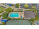 Aerial view of the pool area with lounge chairs, tennis court, and golf carts at 9540 High Gate Dr # 1422, Sarasota, FL 34238