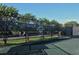 Well-maintained tennis court with a sturdy fence and professional signage for a competitive match at 9540 High Gate Dr # 1422, Sarasota, FL 34238