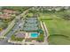 Aerial view featuring the tennis courts, swimming pool, and lush landscaping at 9540 High Gate Dr # 1422, Sarasota, FL 34238