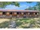 A well-maintained horse barn with a red roof, featuring classic wooden stalls and ample ventilation at 12714 Tyler Run Ave, Odessa, FL 33556