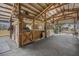Horse barn interior with stalls, fans, and ample space for animal care and shelter and an open-air atmosphere at 12714 Tyler Run Ave, Odessa, FL 33556