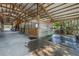 Equine barn interior featuring stalls, a wash rack area, ample open space, storage, and utility access at 12714 Tyler Run Ave, Odessa, FL 33556