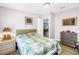 This bedroom has a nautical theme with a ship model on the nightstand and unique furnishings at 12714 Tyler Run Ave, Odessa, FL 33556