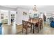 A naturally lit dining room featuring a rustic wood table and decor, and an open floor plan with an adjacent living room at 12714 Tyler Run Ave, Odessa, FL 33556