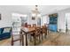 Bright dining room features a wooden table, adjacent to the kitchen with ample space for entertaining at 12714 Tyler Run Ave, Odessa, FL 33556