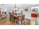 Traditional dining room with wooden table, chairs, and hardwood floors next to the kitchen at 12714 Tyler Run Ave, Odessa, FL 33556