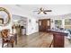 Inviting entryway with wood-look floors, a wooden door, and stylish decor elements at 12714 Tyler Run Ave, Odessa, FL 33556