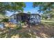 Quaint home with screened porch, landscaping, and peaceful rural setting at 12714 Tyler Run Ave, Odessa, FL 33556