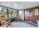 Welcoming front porch with rocking chairs and beautifully crafted door at 12714 Tyler Run Ave, Odessa, FL 33556