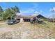 View of open garage with truck, tractor, and boat parked outside at 12714 Tyler Run Ave, Odessa, FL 33556