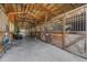Well-maintained horse stalls featuring wooden doors, ample space, and a clean, organized interior at 12714 Tyler Run Ave, Odessa, FL 33556