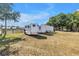 Multiple horse trailers are parked on a green grassy lot, ideal for equestrian events and transport at 12714 Tyler Run Ave, Odessa, FL 33556