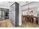 Kitchen with stainless steel appliances, gray cabinets, large pantry adjacent to an ample-sized dining area at 12714 Tyler Run Ave, Odessa, FL 33556
